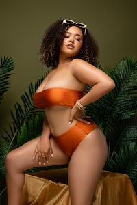 a woman in an orange bikini posing