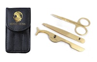 a pair of scissors and a case with a gold trimmer